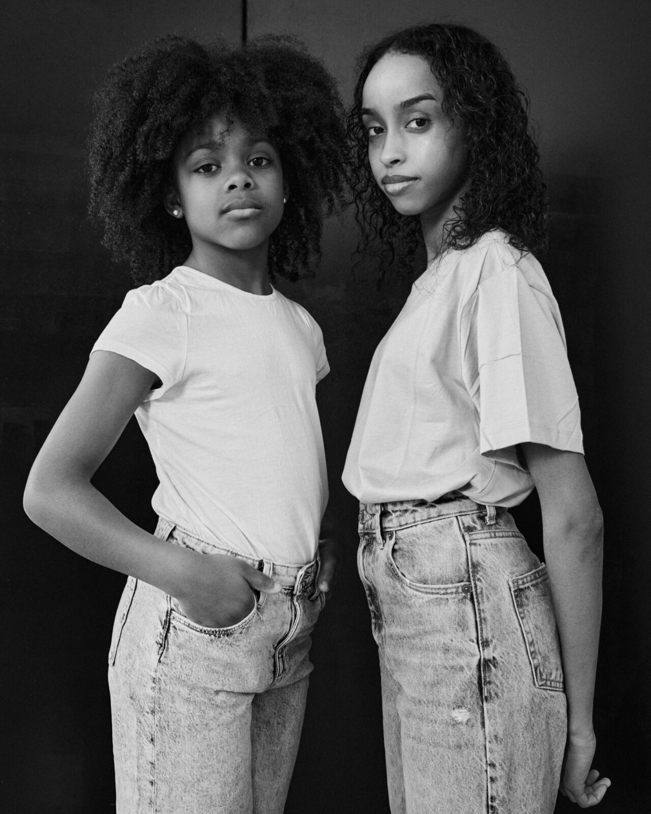 Kids posing in white tshirts and jeans