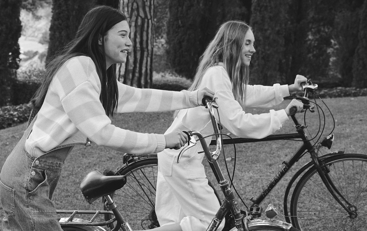 two girls riding bikes and smiling